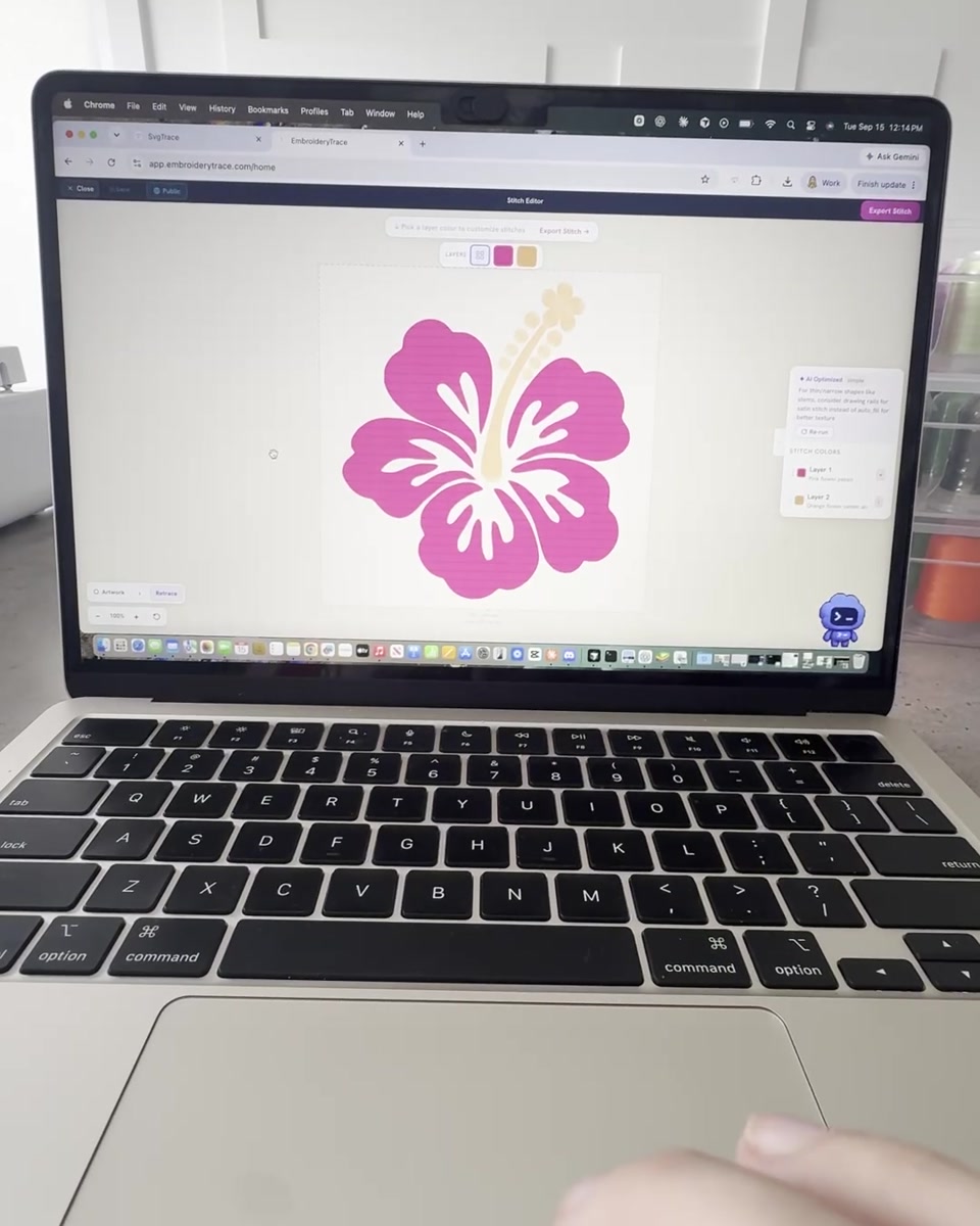 Pink and yellow hibiscus design open in the actual Trace editor on a MacBook.